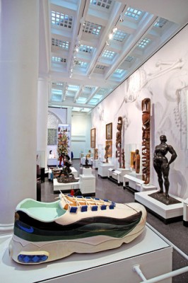 “Connecting Cultures” installation, with Ghanaian artist Paa Joe’s Coffin in the Form of a Sneaker, foreground, and Gaston Lachaise's Standing Woman, right, with New Guinea ancestral figures behind them. Photograph by Marilynn K. Yee.